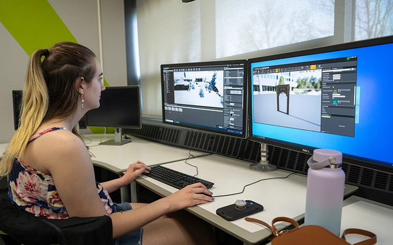 A student develops a game in the Game Design Lab.