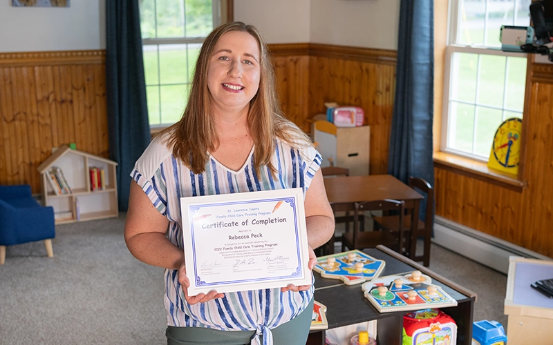 Rebecca Peck holds an award in her daycare center.