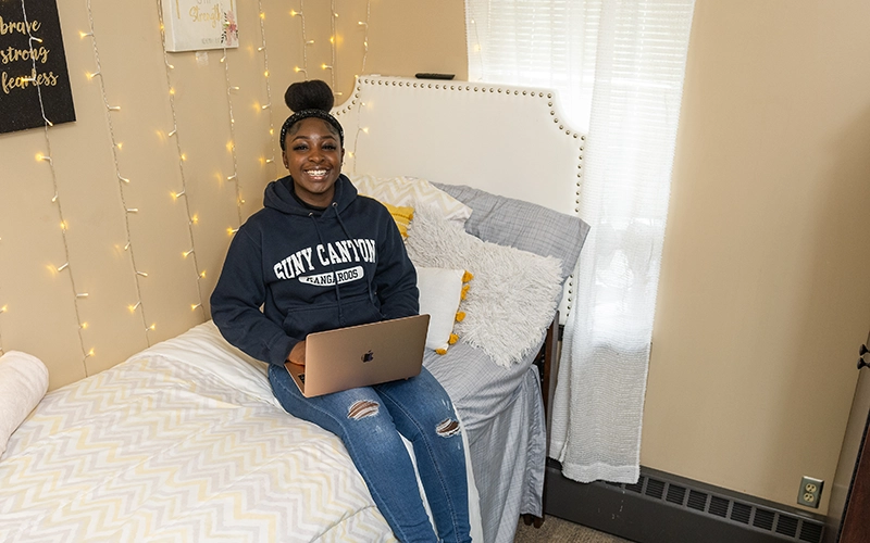 A student celebrates having a single room in Kennedy Hall.