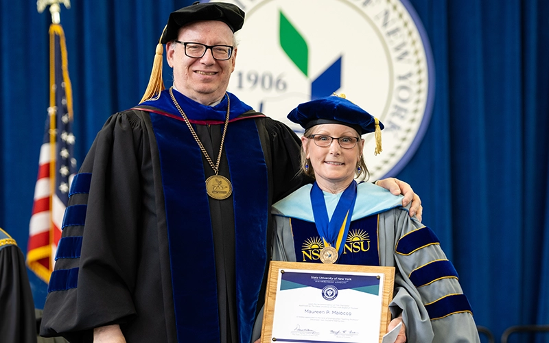 President Szafran presents Maureen Maiocco with the SUNY Distinguished Teaching Professorship.