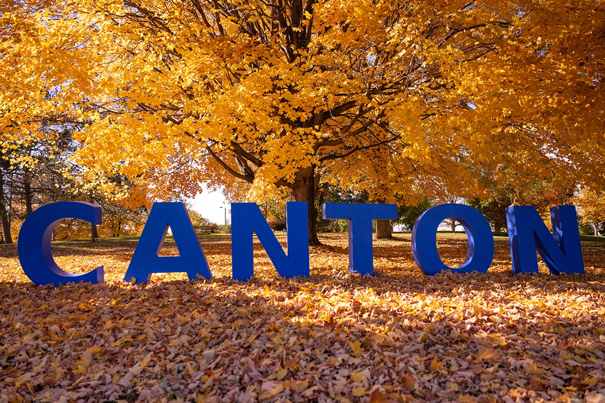 Large blue letters spell out CANTON on a hillside during a gorgeous fall day.