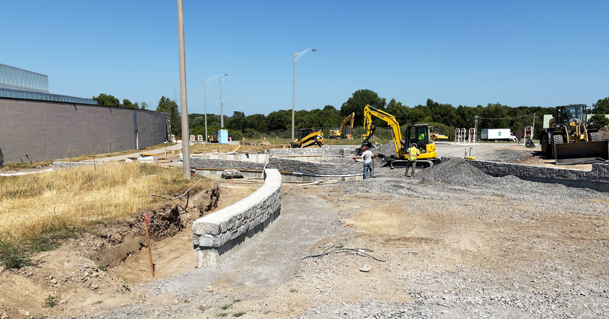 Construction of the parking lot and sidewalk next to the turf field.