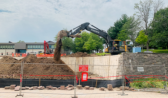 Crews work to clear the Roselle Plaza outside French Hall.