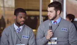 Two students conduct a pre-game intro