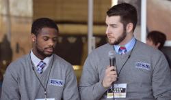 Two students conduct a pre-game intro