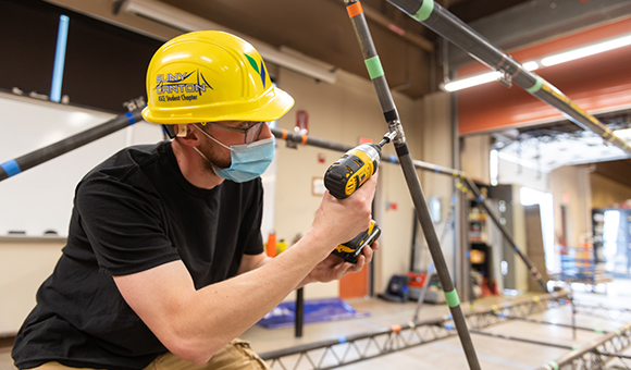 SUNY Canton Steel Bridge Team build captain Stephen Schermerhorn finishes a connection on the college’s 2021 entry for the American Institute of Steel Construction Student Steel Bridge Competition.