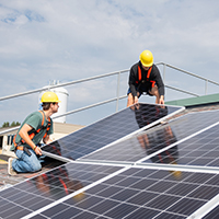 Students installing solar panels.