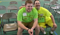 A student sits with a Special Olympian.