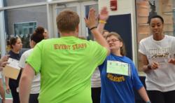 A student high-fives a Special Olympian.