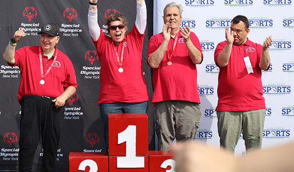 Athletes receive medals at the podium during the Special Olympics Fall Classic.