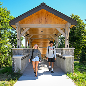 Two students reach the top of one of two new staircases connecting the residence halls to academic classrooms.