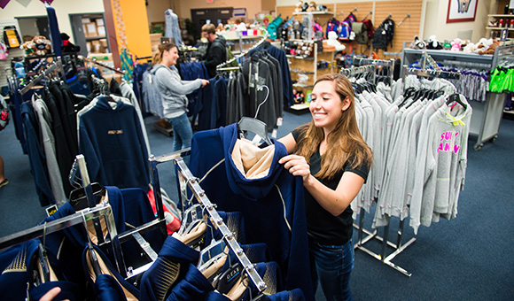 A student browses for hoodies at the Campus Store