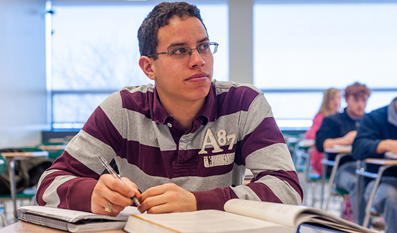 A student writes notes during class.