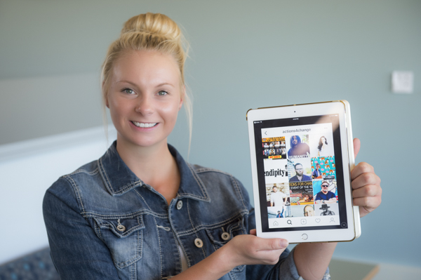 Management major Tia M. Tassava holds an iPad.