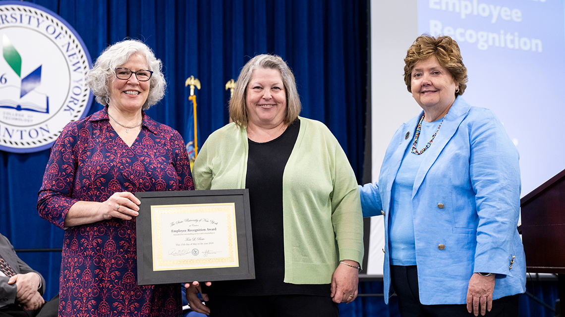 Toni Besio is presented the Employee Recognition Award by College Council members Kathy Dodge and Jenn Stevenson.