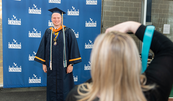 Tyler Bowman has his graduation picture taken by Cristina Fenner of Cristina Fenner Photography.