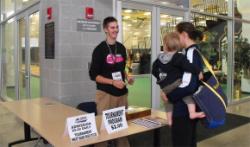 Students greet spectators at the door.