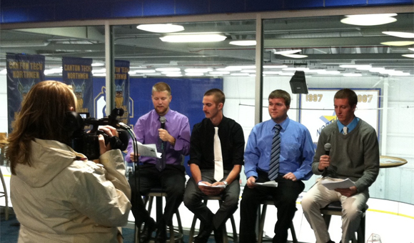Students record a pre-game show prior to a men's basketball game.
