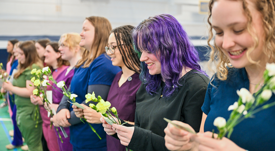 Graduates lined up, read the oath during the Veterinary Technology pinning ceremony.