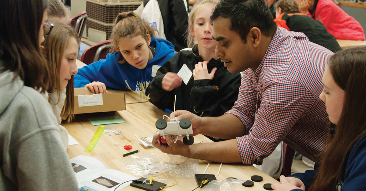 Dr. Roman Kibria works with students during Women in Engineering Day
