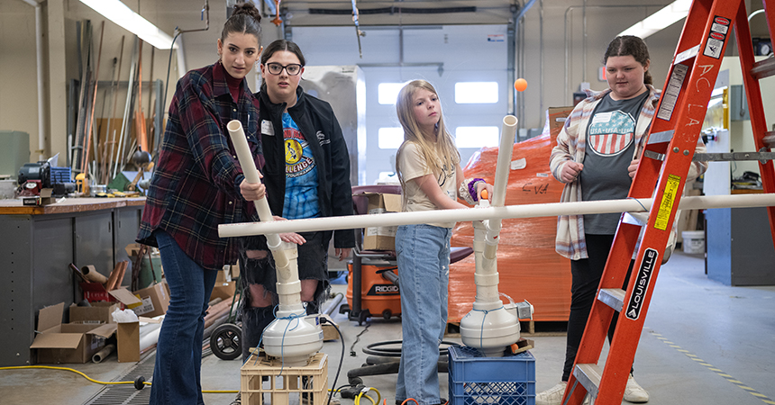 Students participate in a ping pong ball launching competition at Women in Engineering Day.