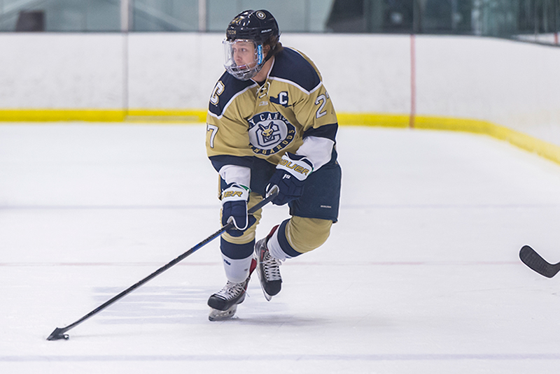 Forward Joe Deveny breaks away with the puck.